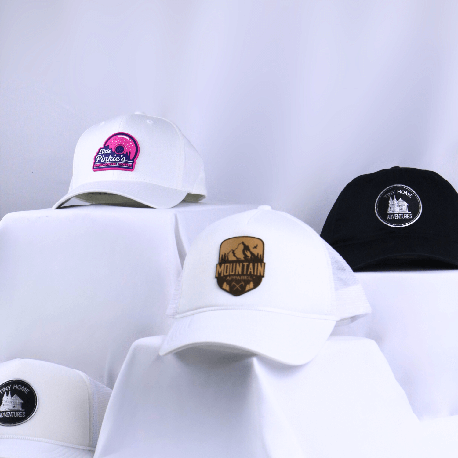 4 different custom patch hats with a white backdrop