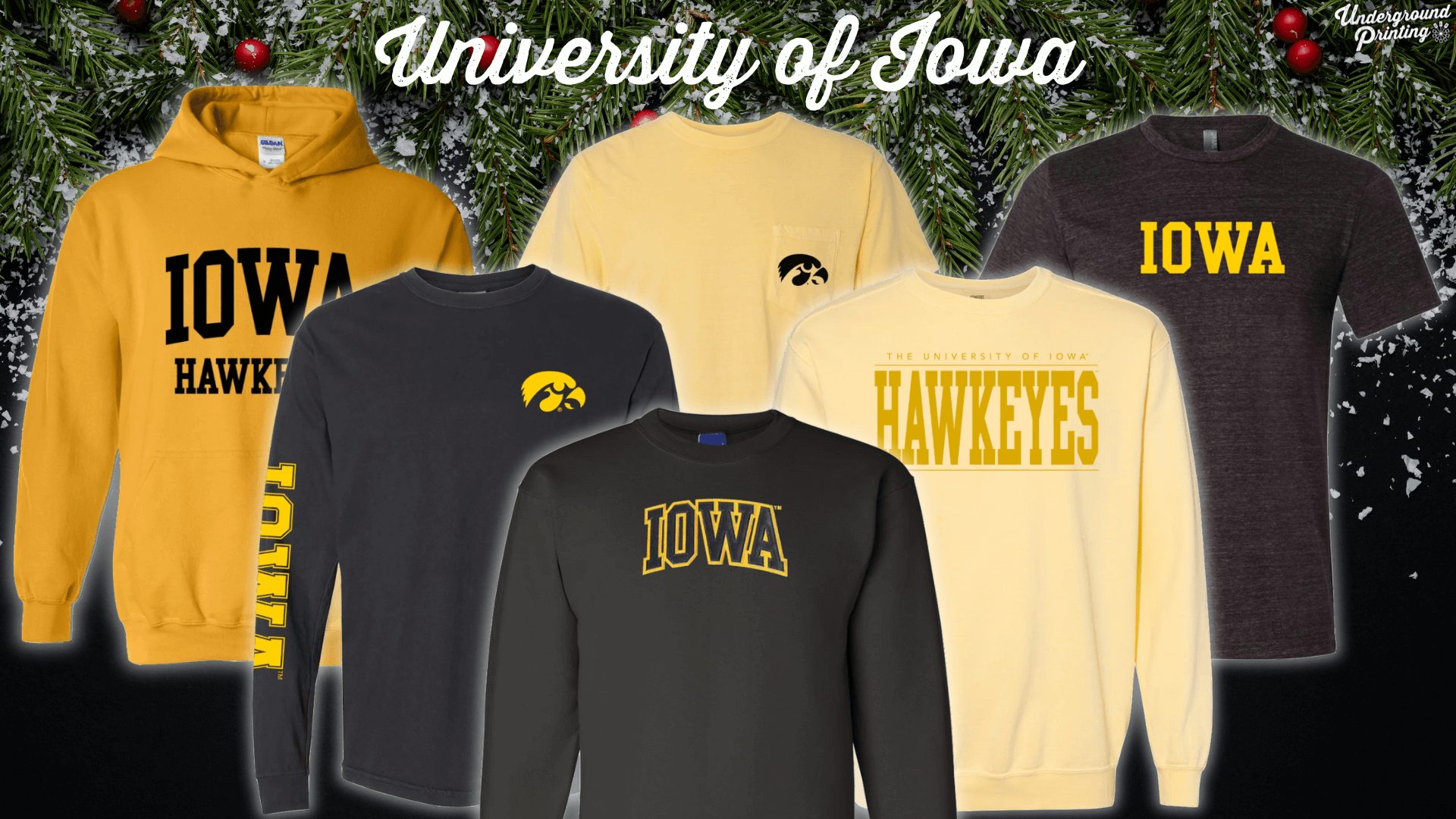 A collection of University of Iowa clothing in black and gold, featuring T-shirts, sweatshirts, and hoodies with "Iowa Hawkeyes" and Iowa logo text.