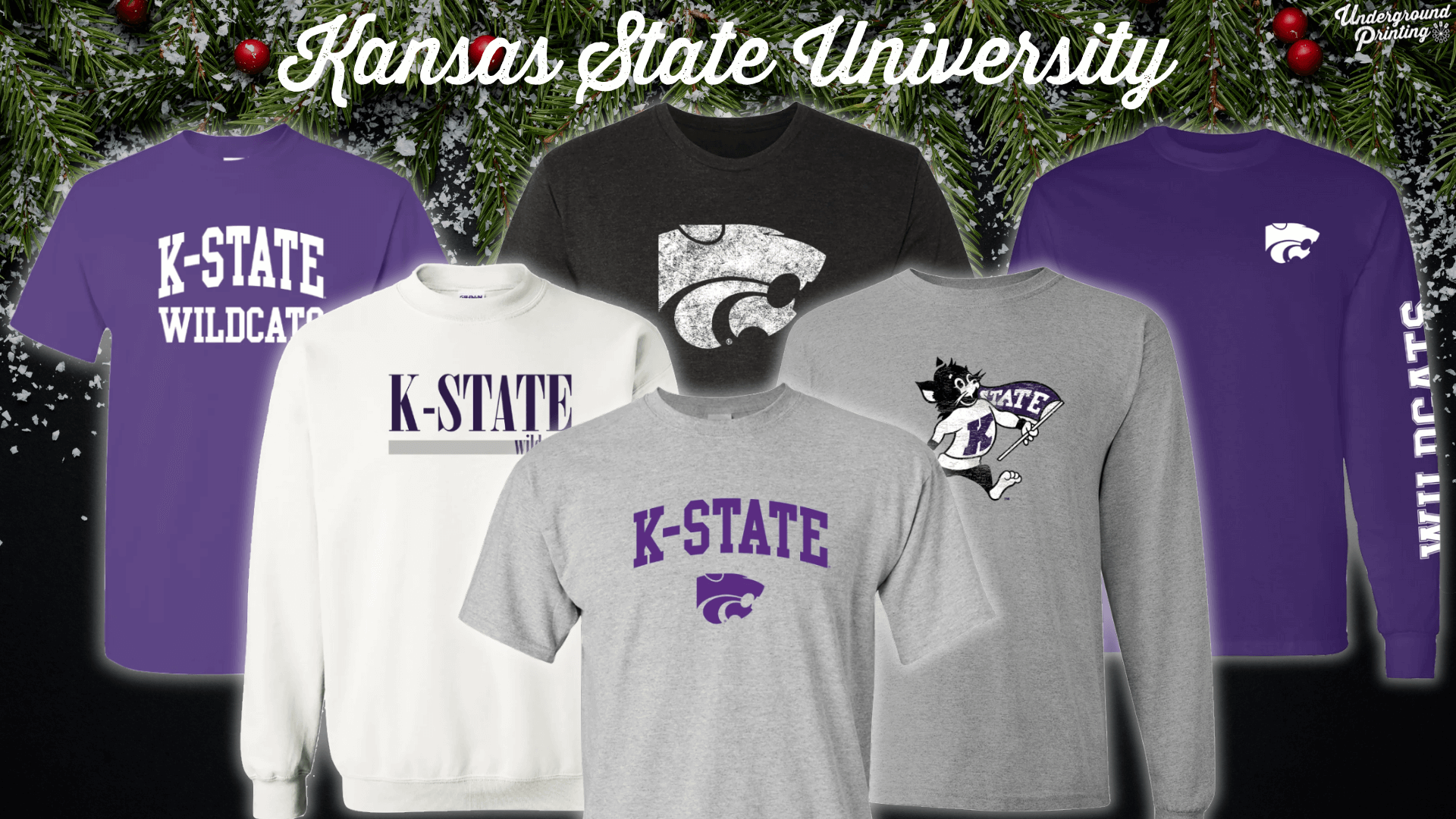 A collection of Kansas State University apparel, showcasing items with "K-State Wildcats" and the iconic Powercat logo. The pieces include a purple t-shirt with "K-State Wildcats," a black t-shirt with a large, distressed Powercat graphic, a white sweatshirt with "K-State Wildcats" printed across the chest, a gray t-shirt with a playful Wildcat mascot holding a flag, and a purple long-sleeve shirt with "Wildcats" down the sleeve.