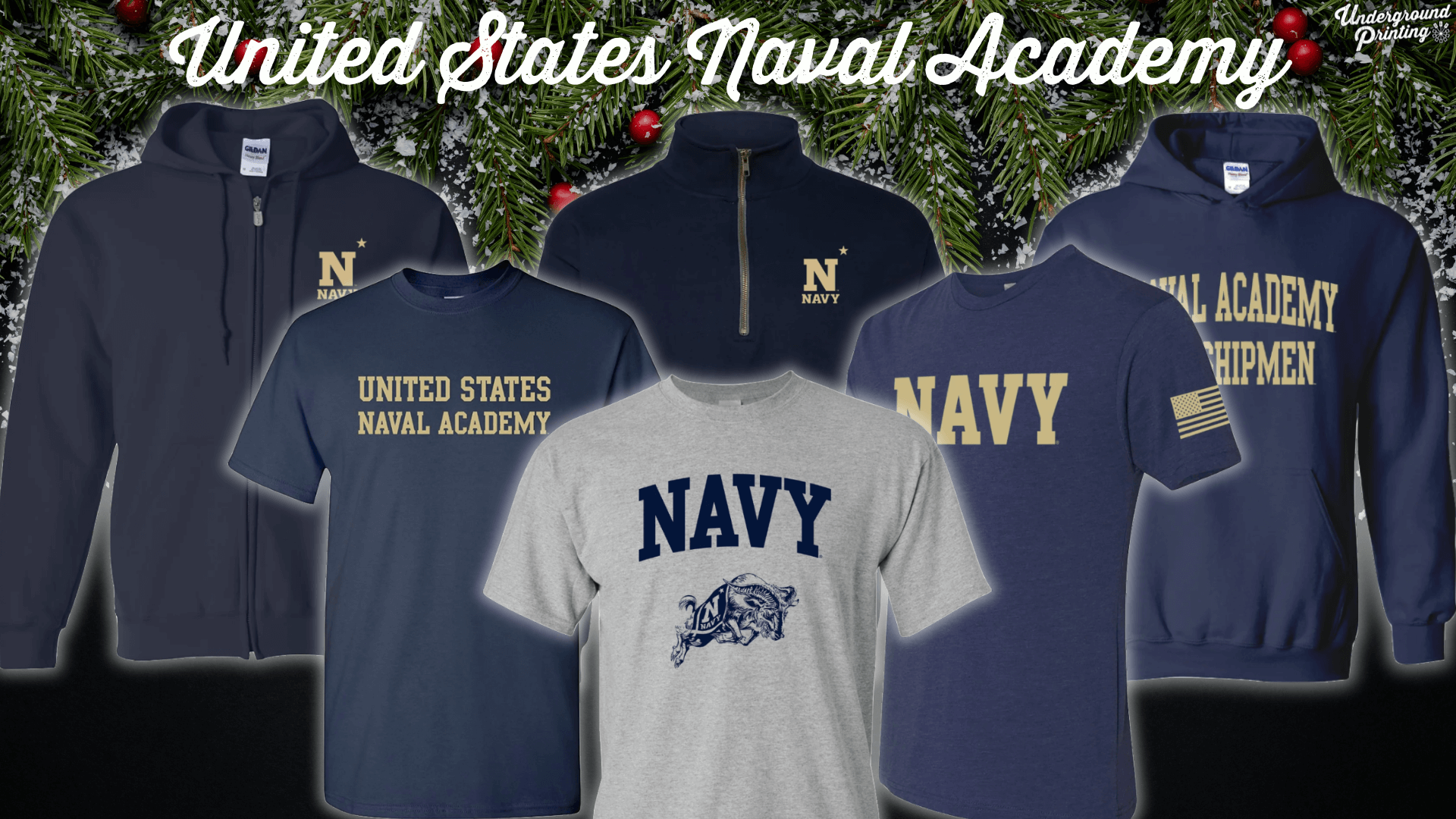  A variety of United States Naval Academy clothing items, featuring the classic navy and gold theme. Items include a navy zip-up hoodie with "N" and "Navy" on the chest, a navy quarter-zip with the "N" logo, a gray t-shirt with "Navy" and the Naval Academy's mascot, a blue shirt with "United States Naval Academy," a navy t-shirt with "Navy" and a U.S. flag patch on the sleeve, and a navy hoodie with "Naval Academy Midshipmen" printed across the front.