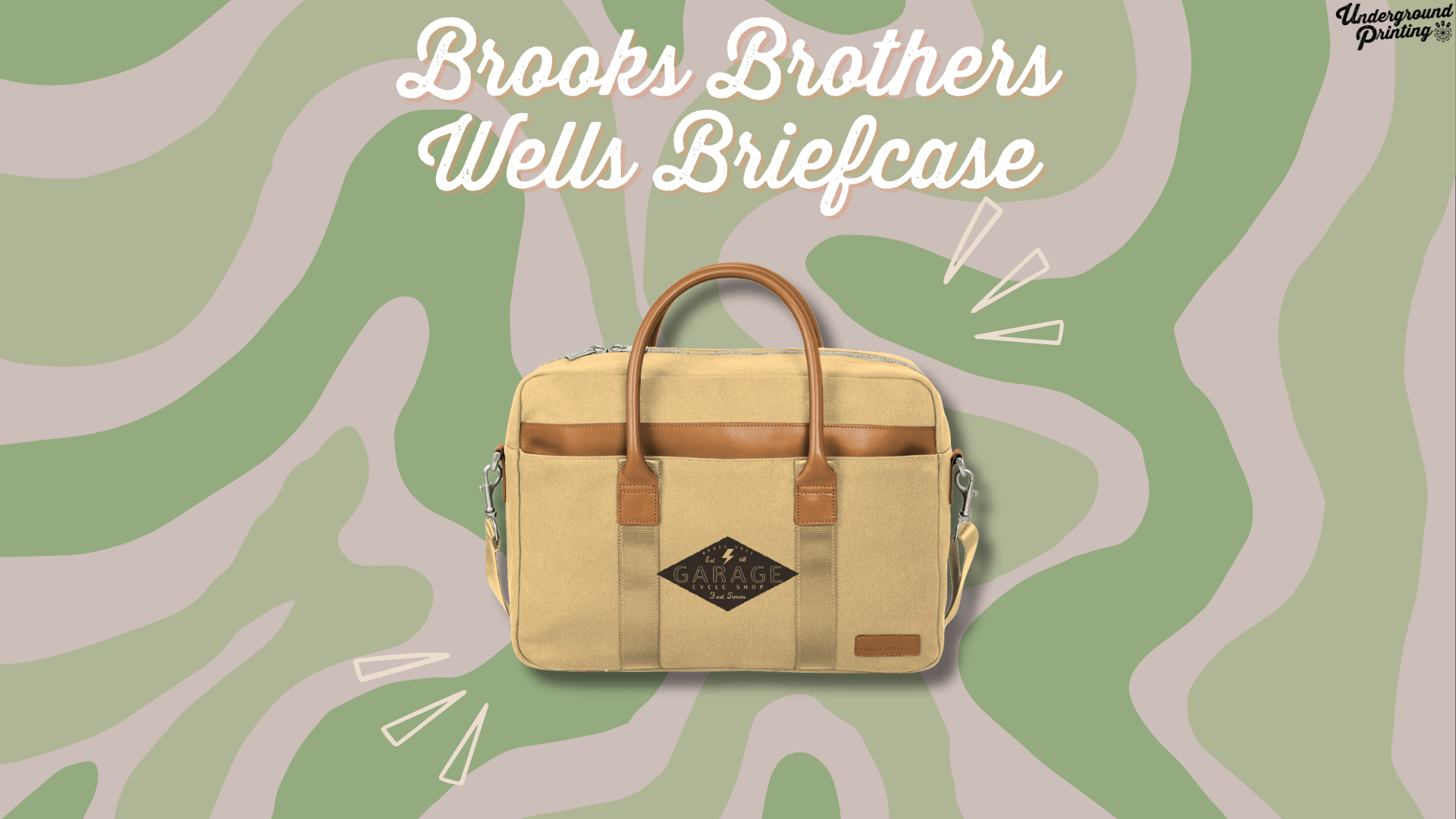 A tan canvas briefcase with leather accents and handles, featuring a custom logo reading "Garage Cycle Shop." The briefcase is displayed against a green and beige camouflage-style background with decorative lines emphasizing the product.