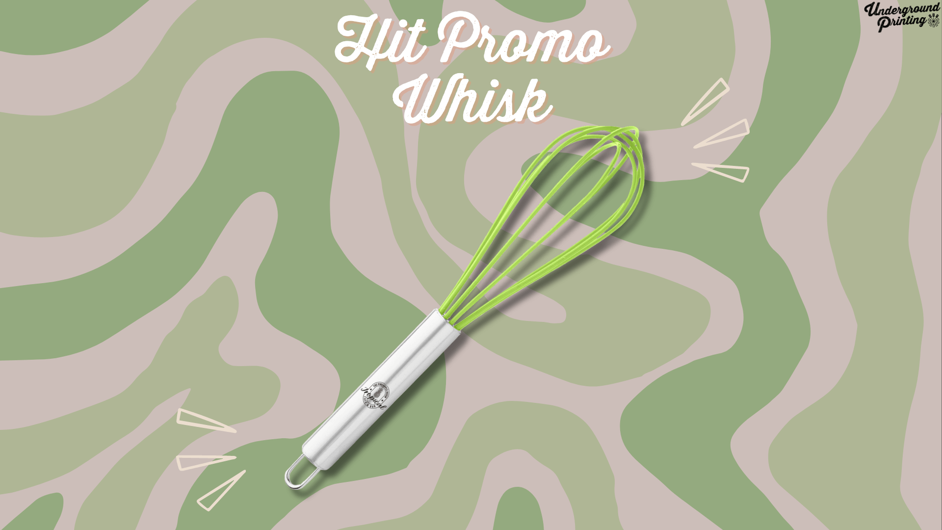 A stainless steel whisk with a bright green silicone head, branded with a logo on the handle. Displayed on a green and beige camouflage-style background with decorative accent lines drawing attention to the whisk.