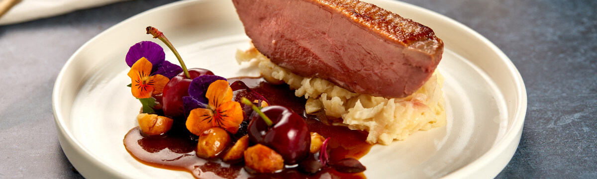 Duck with cherry and butterbean mash