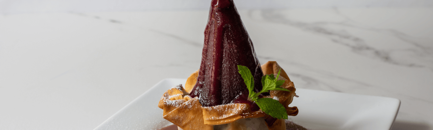 Poached pears in filo pastry with amaretti and a caramel toffee sauce