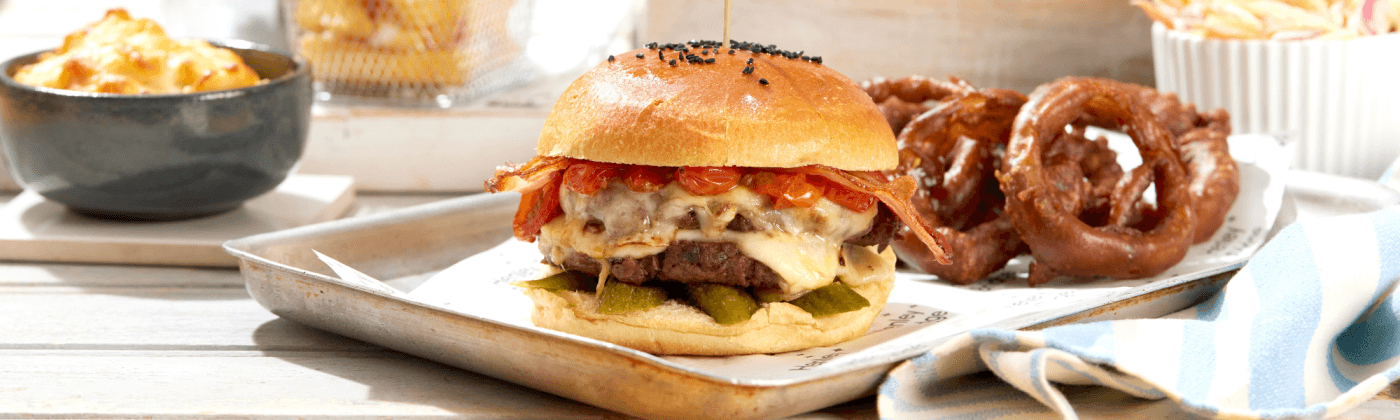 Decadent beef burger with a feast of accompaniments