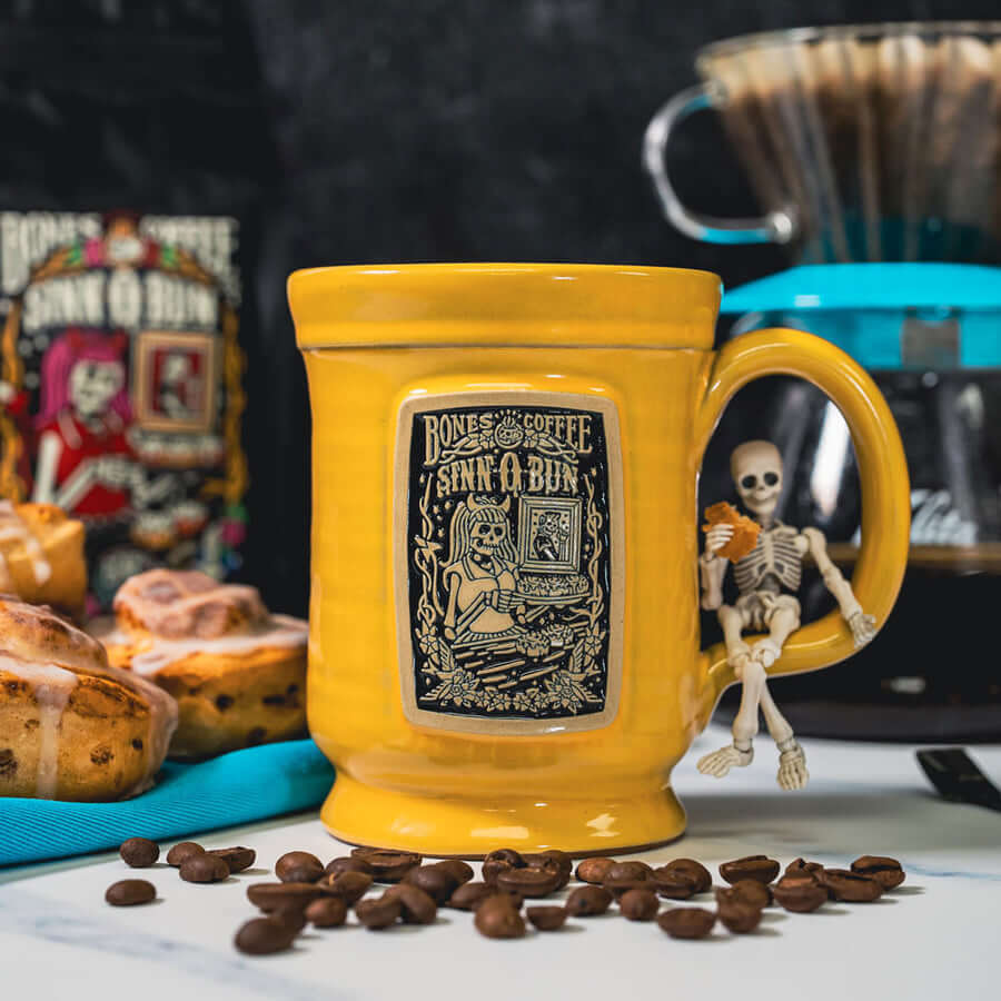 yellow Sinn-O-Bun mug with coffee beans