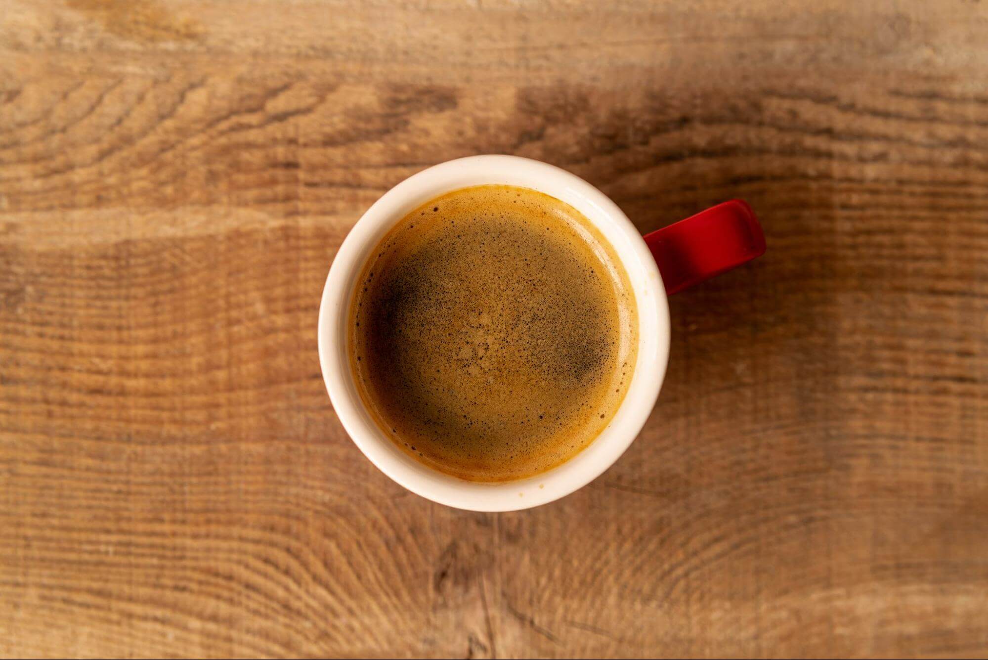 top view cup of coffee on wooden surface