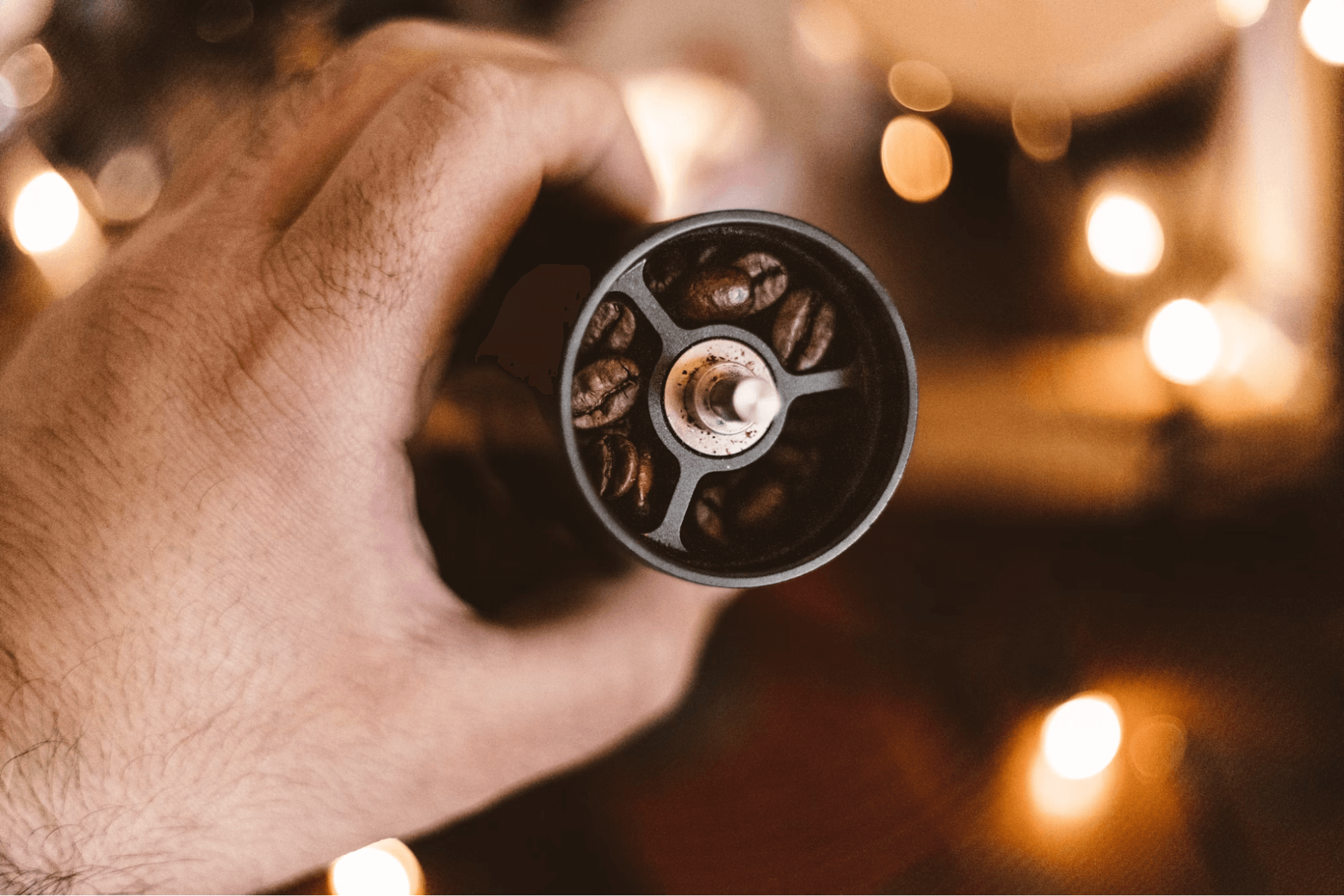 coffee beans inside manual coffee grinder