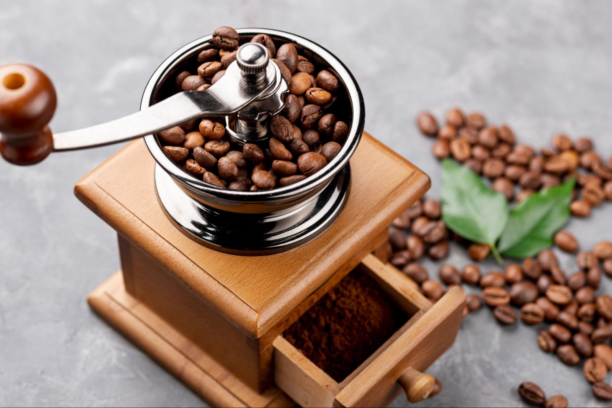  coffee beans and grounds in manual coffee grinder