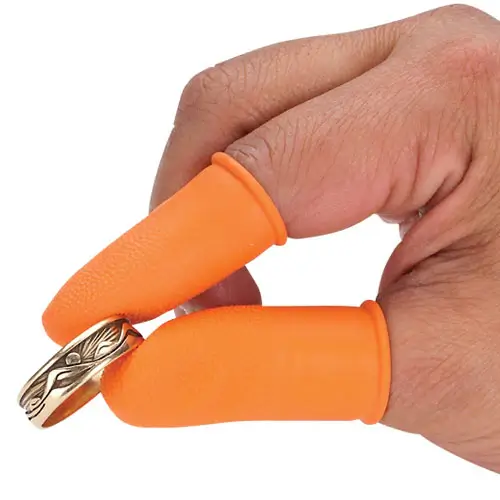 Orange Finger Guards on a jeweler's hand holding a gold ring.