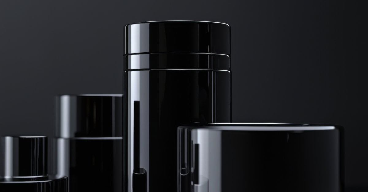 Several stylish black containers with smooth matte finishes stand arranged in a modern, minimalist design.