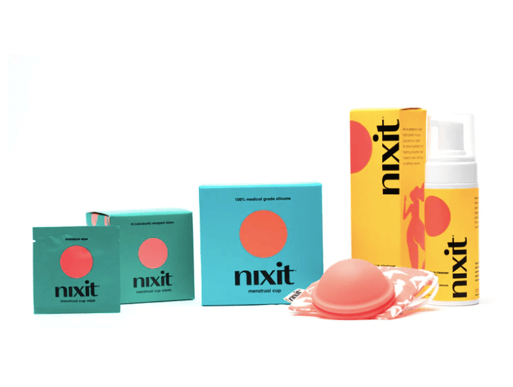 a menstrual disc in the middle of other period care products