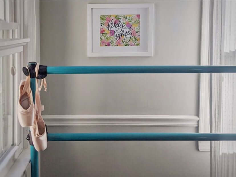 a dance barre with point shoes hanging off of the side