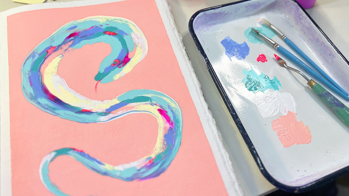 A Chance to Press Restart on the New Year blog header, depicting a painting of a snake next to a paint palette. Created by Teri Hendrich C.