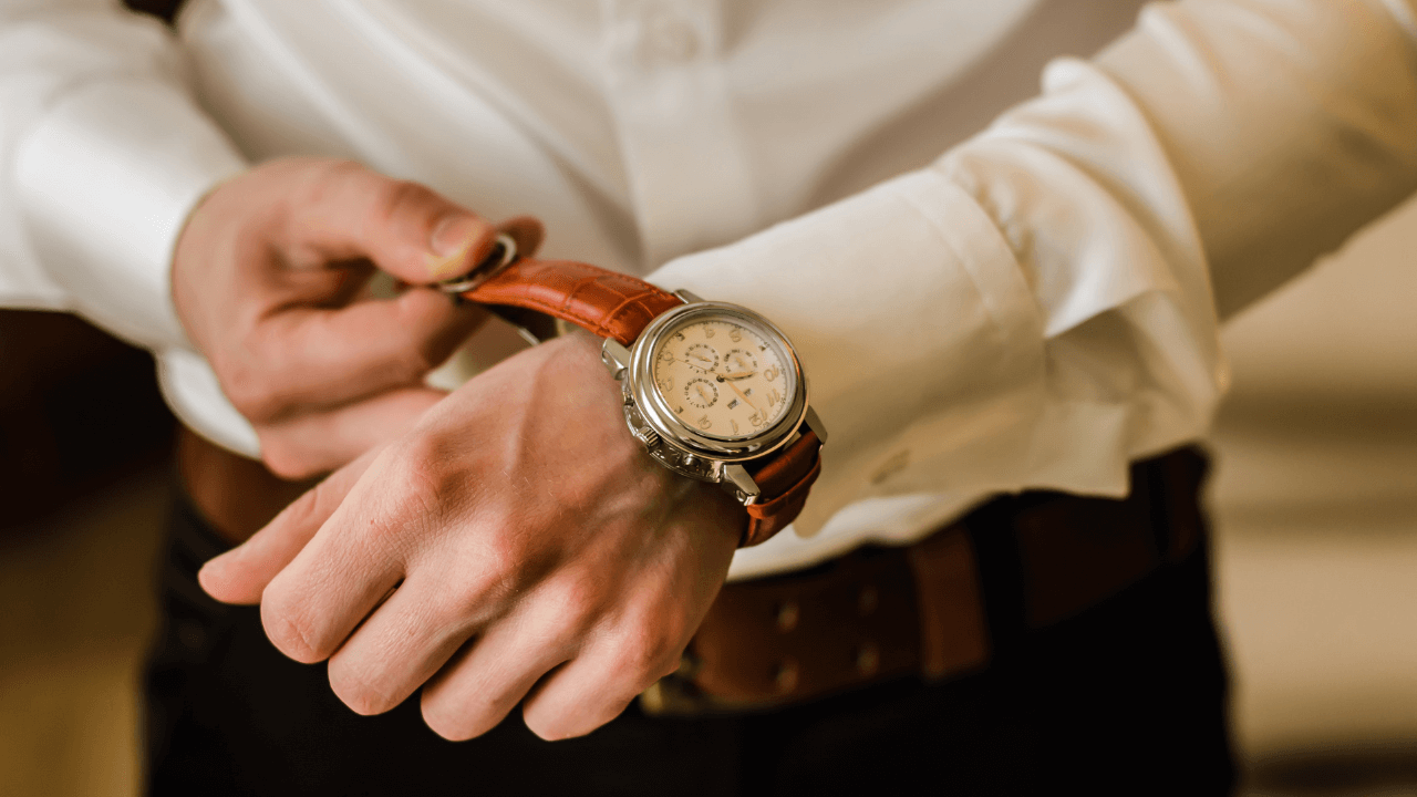 a man wearing a leather strap watch 