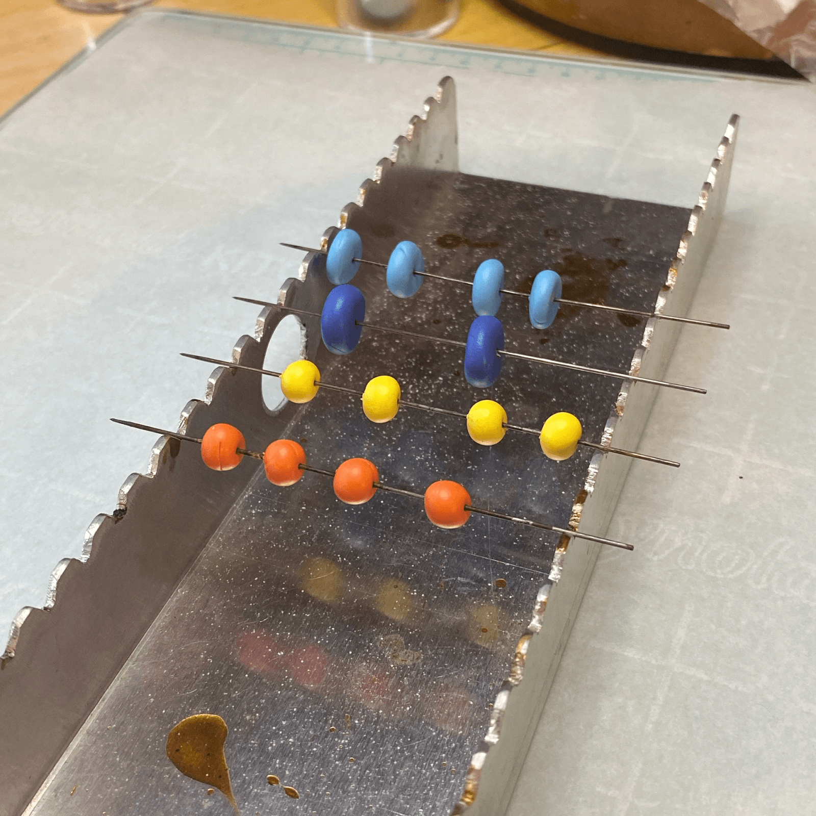 Polymer Clay beads on pins, ready for the oven