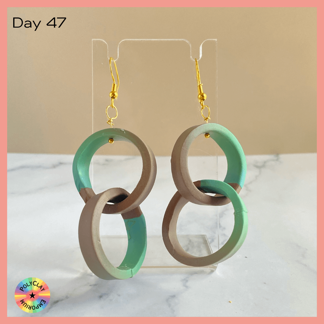 Double hoop polymer clay earrings, made from a green to brown skinner blend.