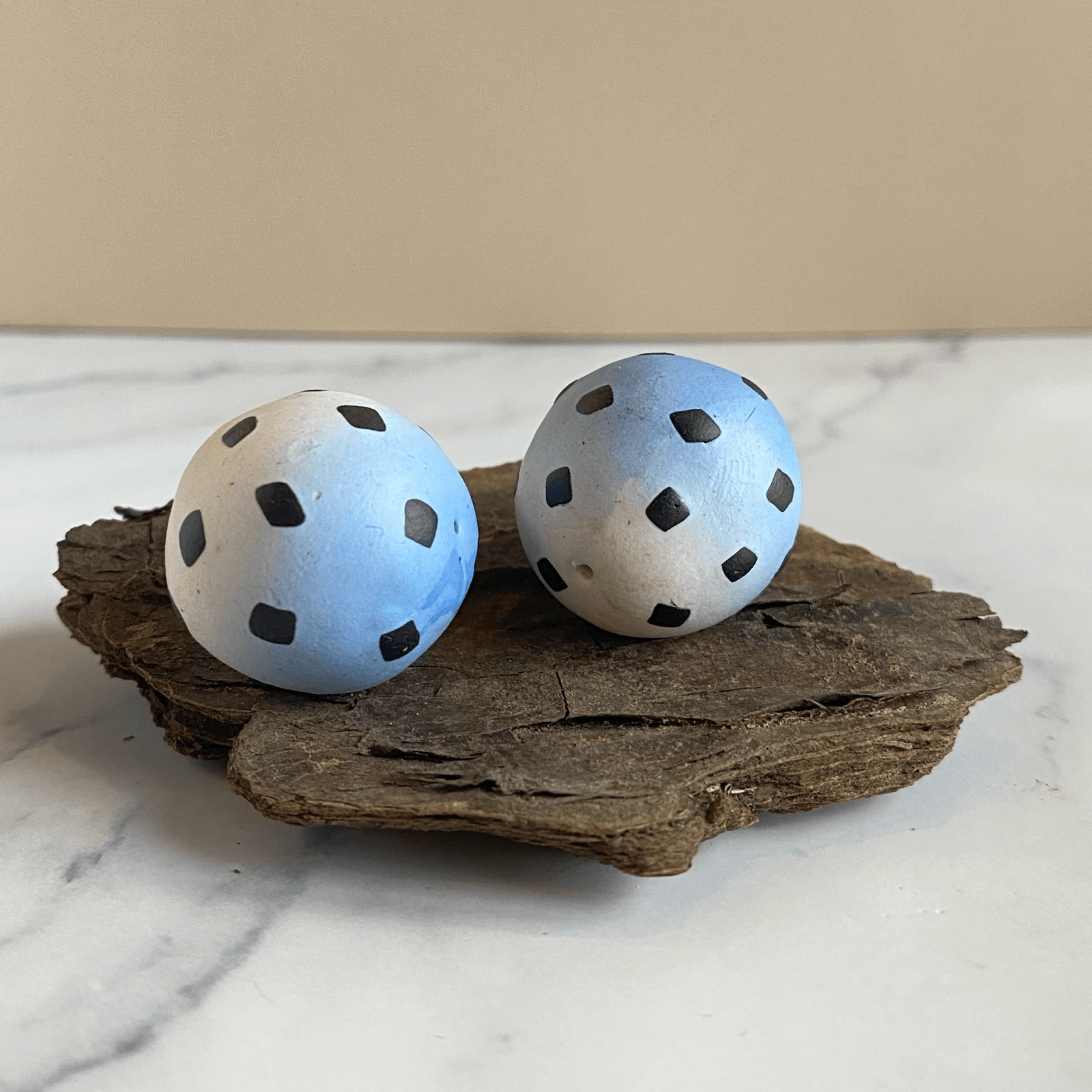 The skinner blend beads decorated with square black polka dots. 
