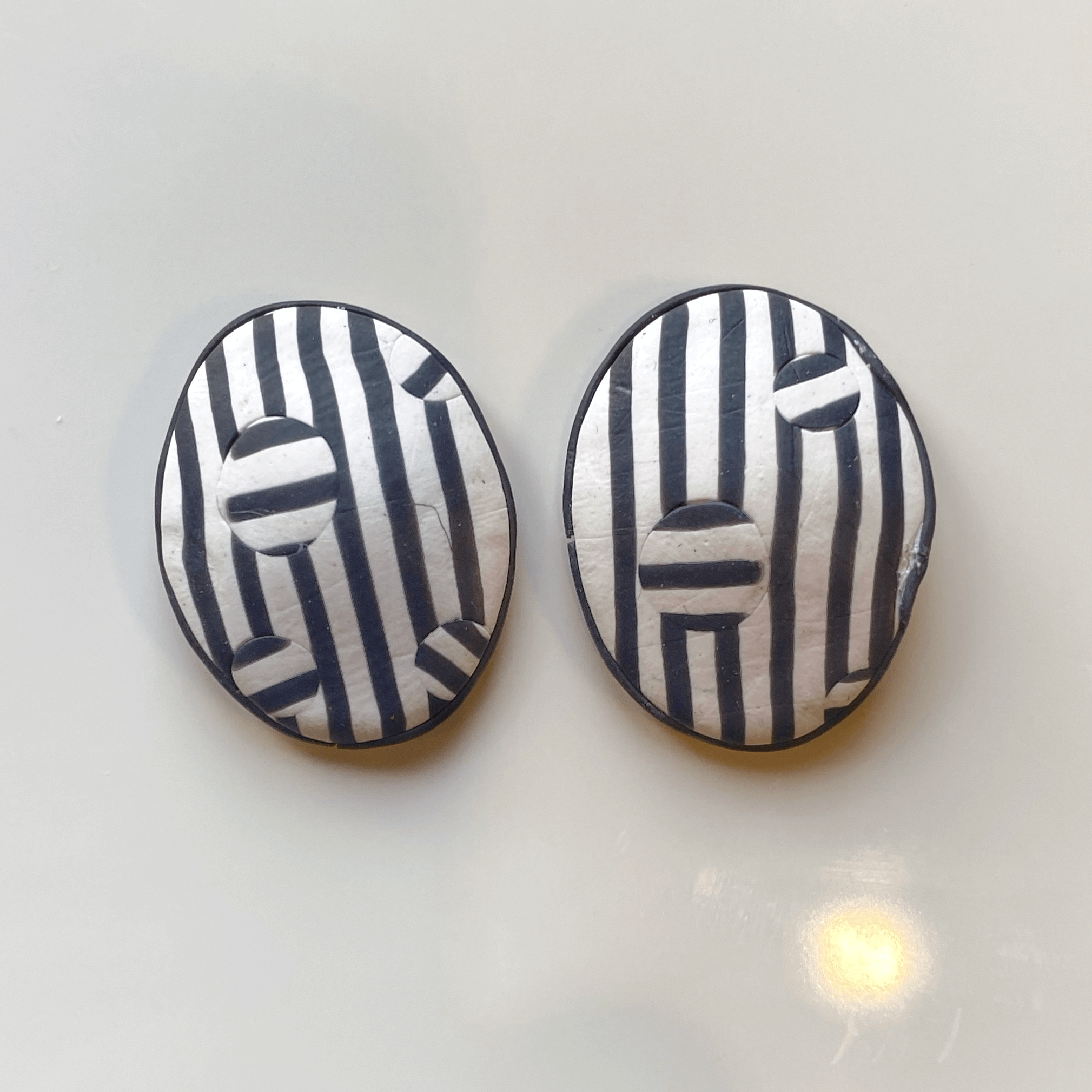 Black and white polymer clay earrings ready for the oven.