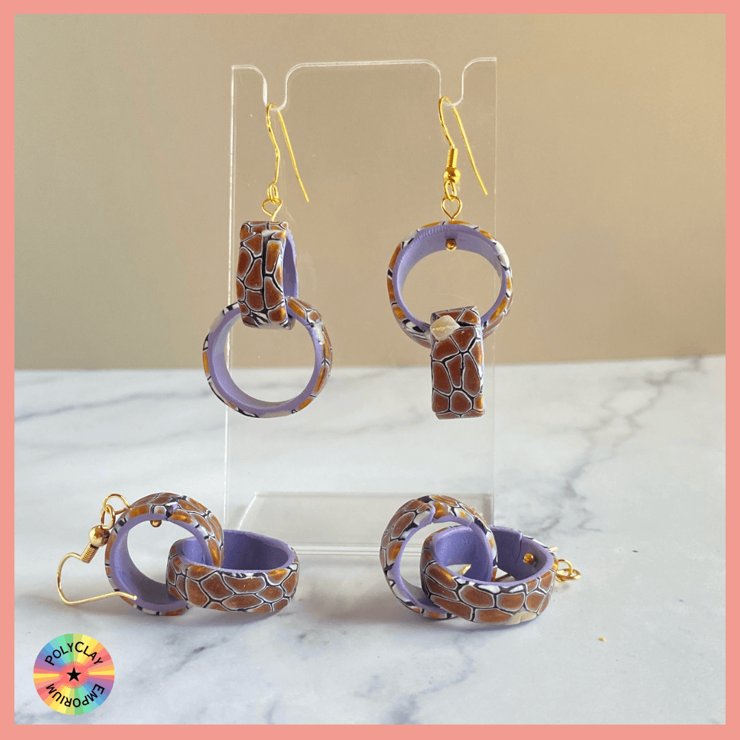 A pair of double hoop polymer clay earrings, brown blend on the outside, bright lavender inside.