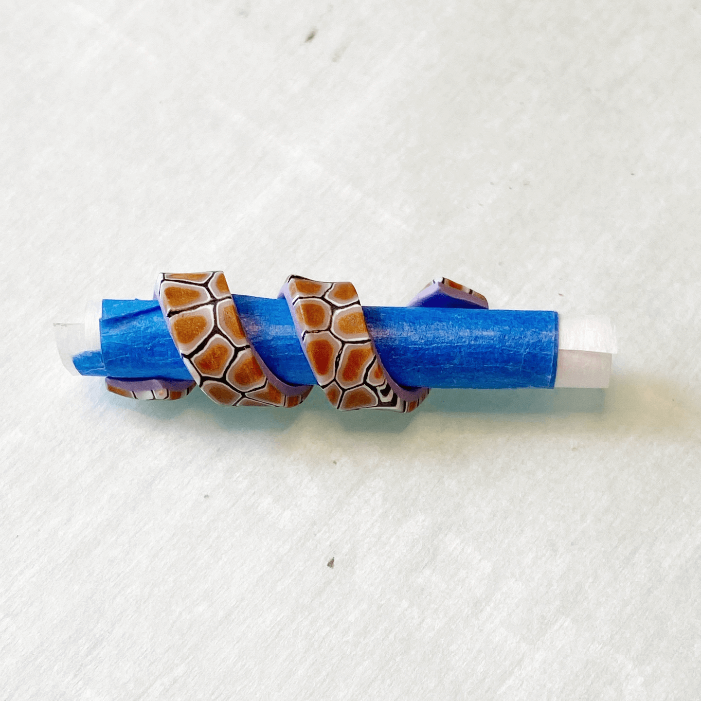 polymer clay wrapped around a paper and tape tube
