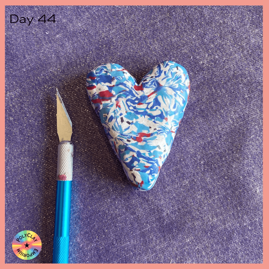 Polymer clay heart covered with a red white and blue marbled slab