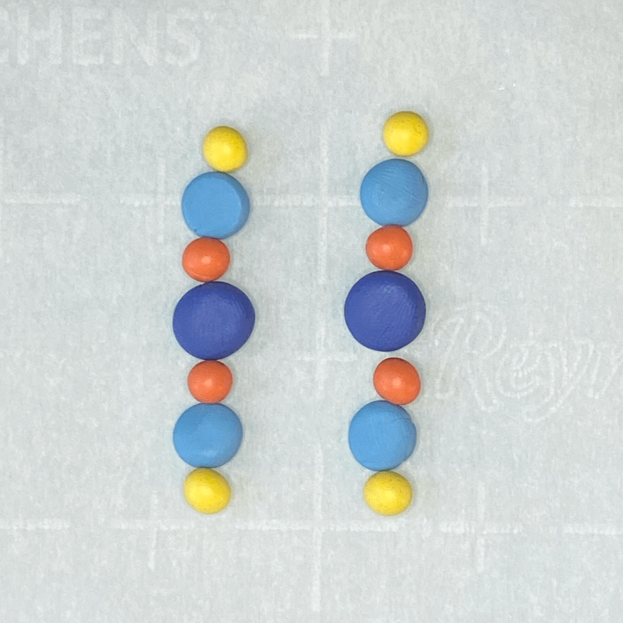 Polymer clay beads lined up in earring order