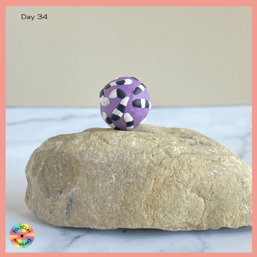 Polymer Clay Bead- a saturated pastel lavender with black and white decorations