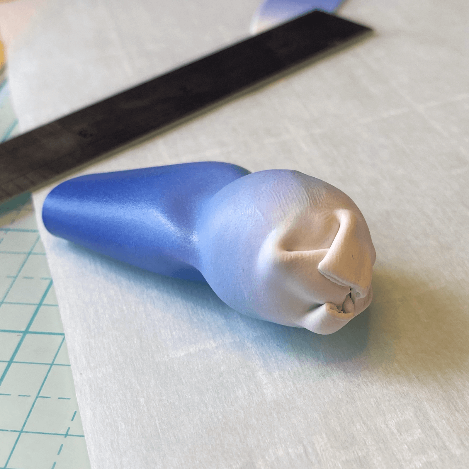 Folding excess polymer clay in at the white side of the bead.
