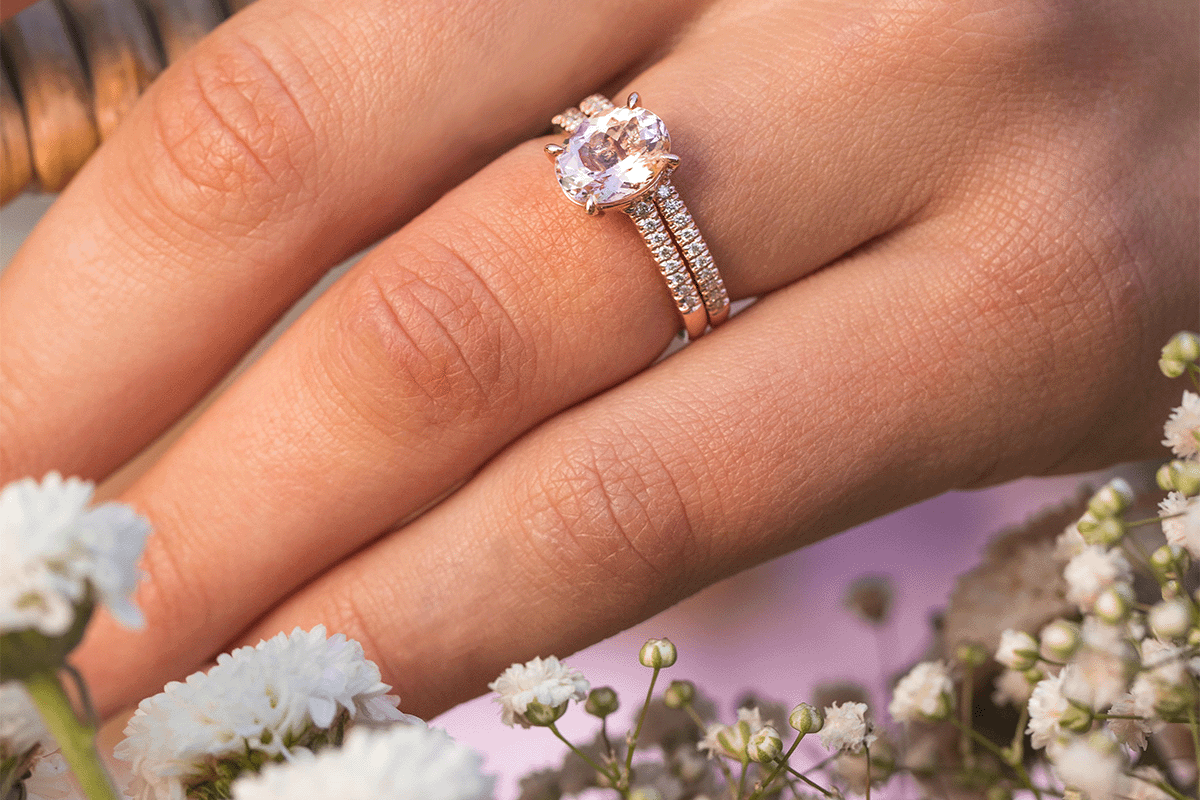 Hand with minimalist ring and flowers purple