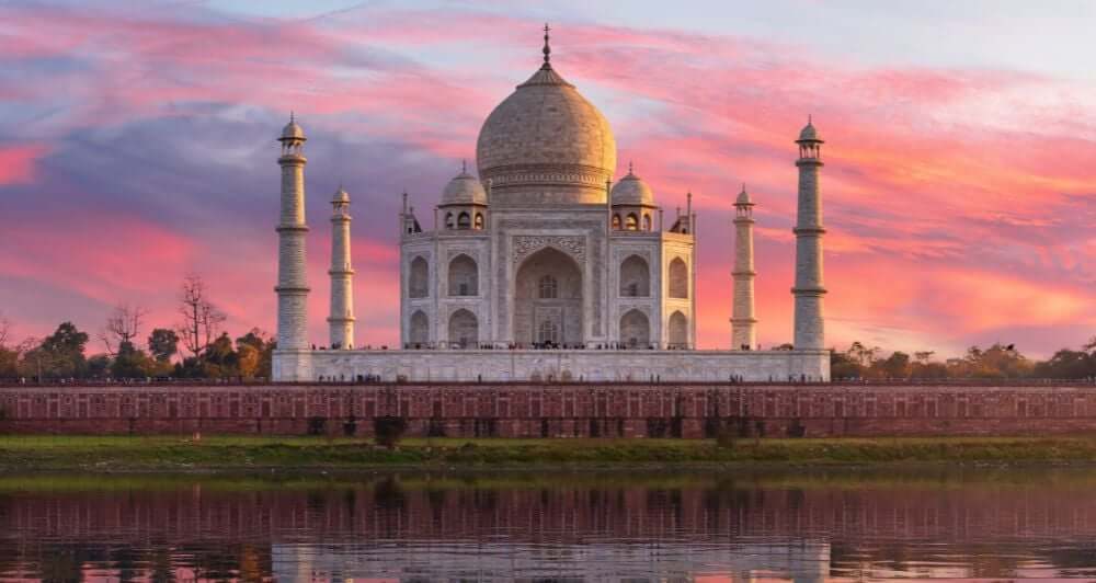 the Taj Mahol at sun set, pink and purple sky 