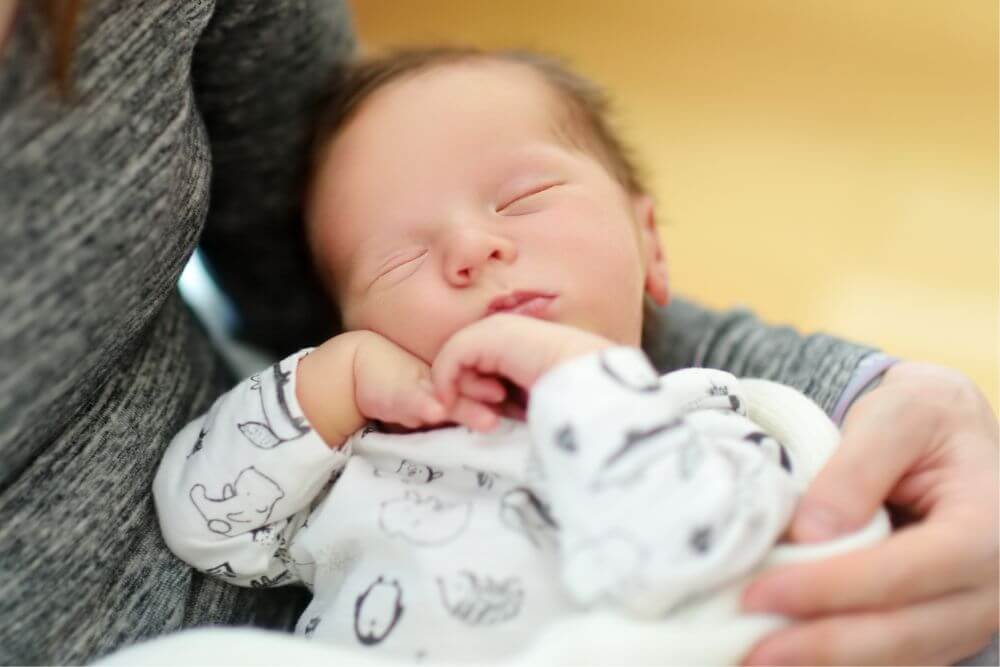 Why do Newborns Sleep With Their Arms Up: Is It Normal?