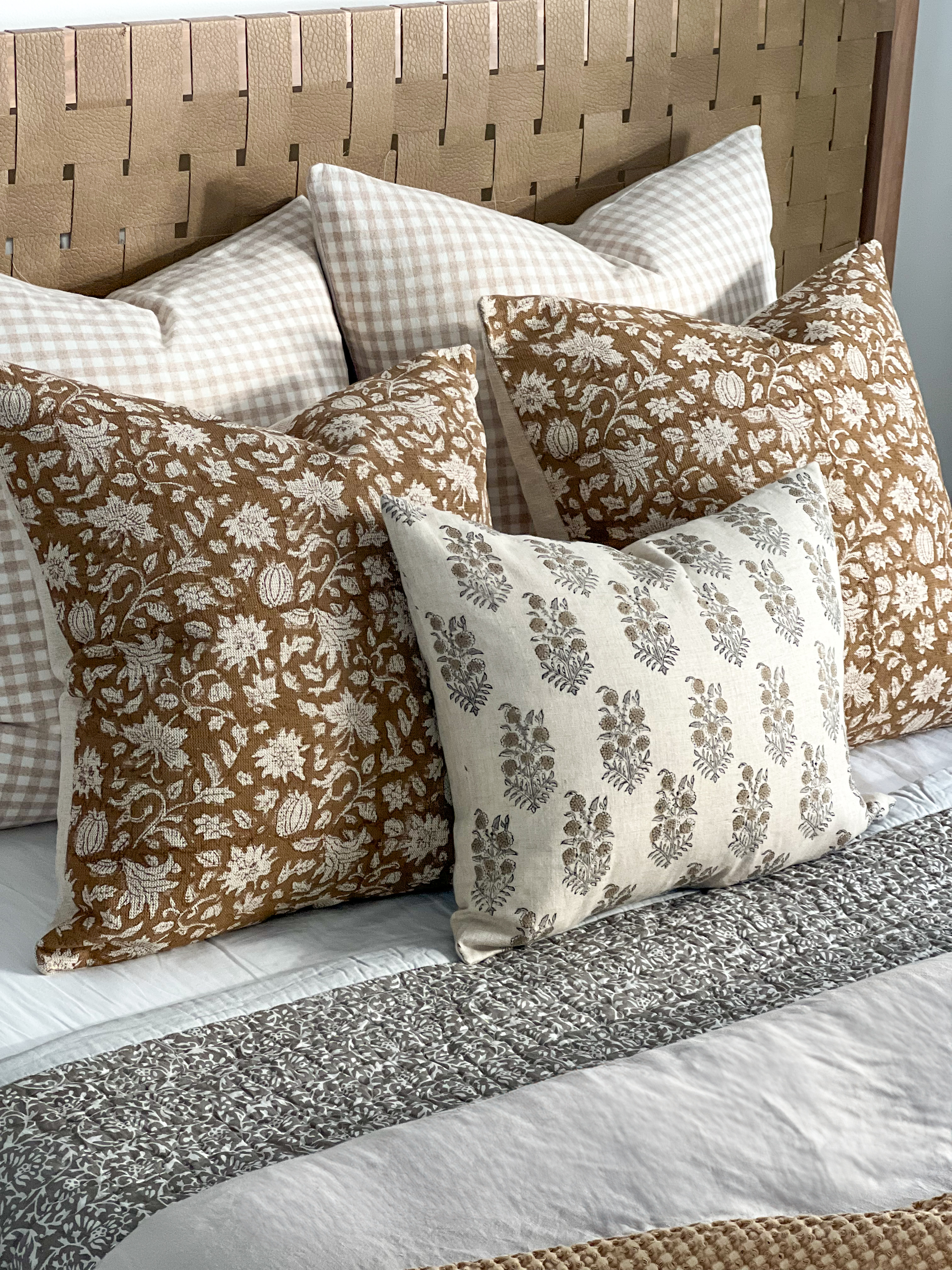 Bed made with block print cushions and quilt.