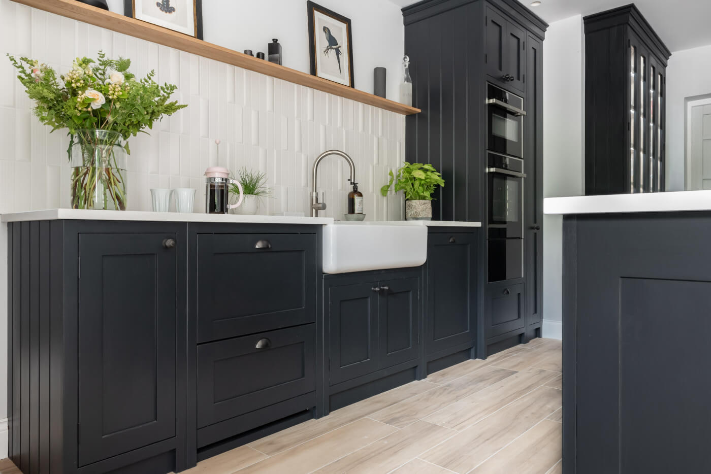 Luxuriously dark cabinetry with a white sink by Shaws of Darwen
