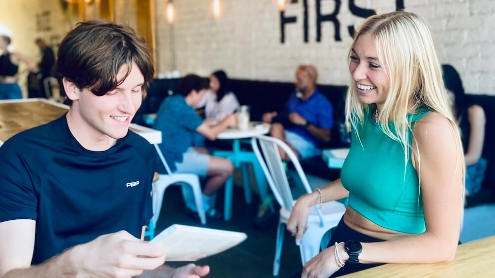 Girl and guy grab a coffee after pickleball match.