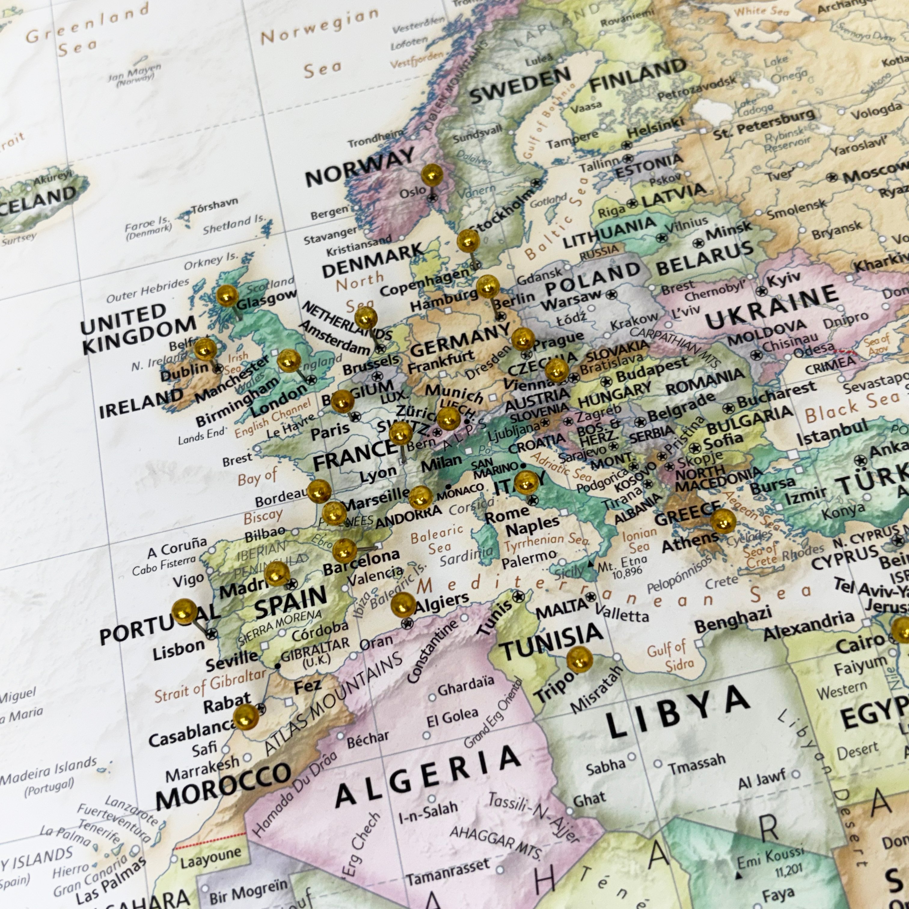 Push Pin World Map - Image focusing on Europe, with several metallic pins marking locations