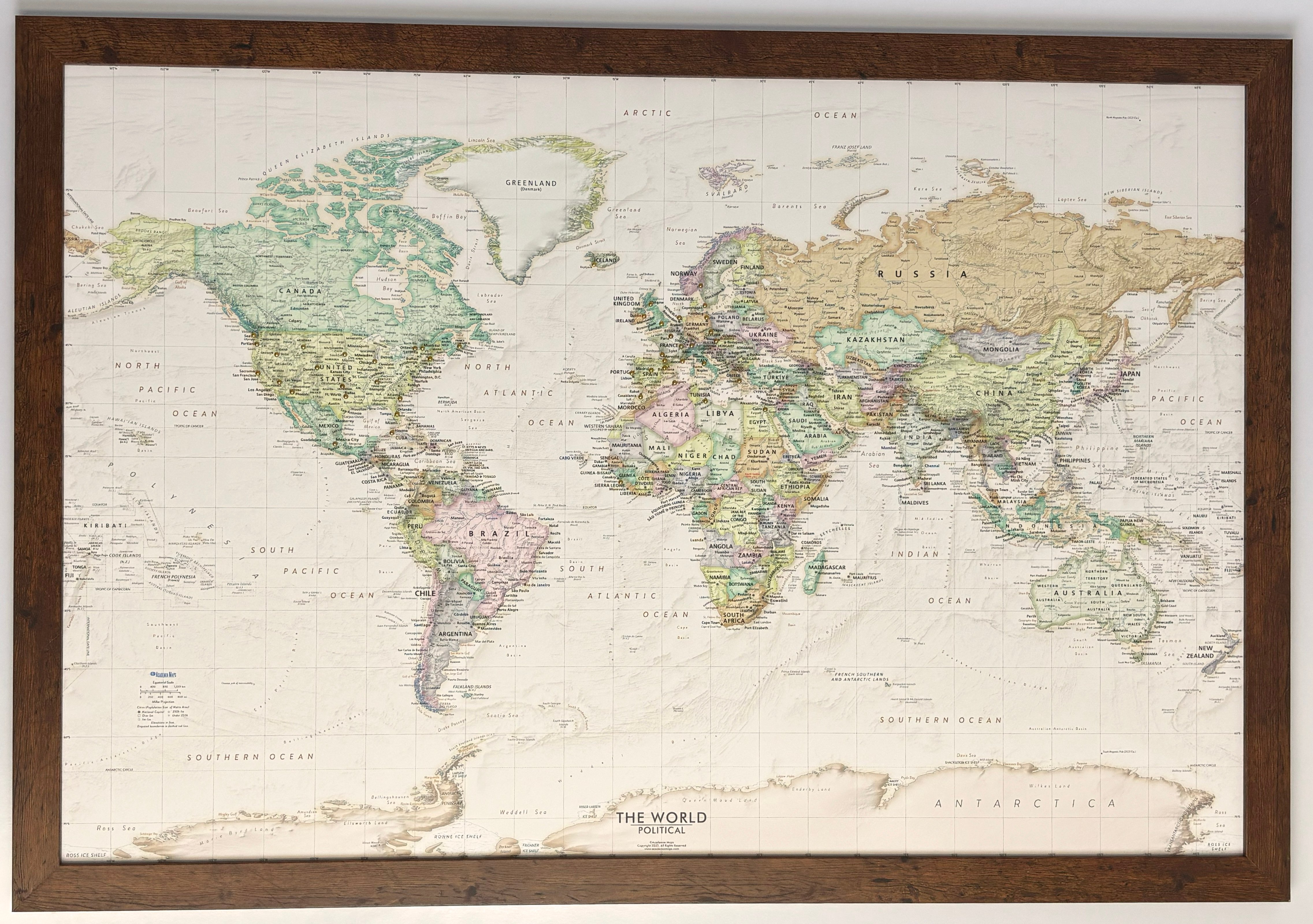 Framed Push Pin Map of the World, Shown Hung on a Wall