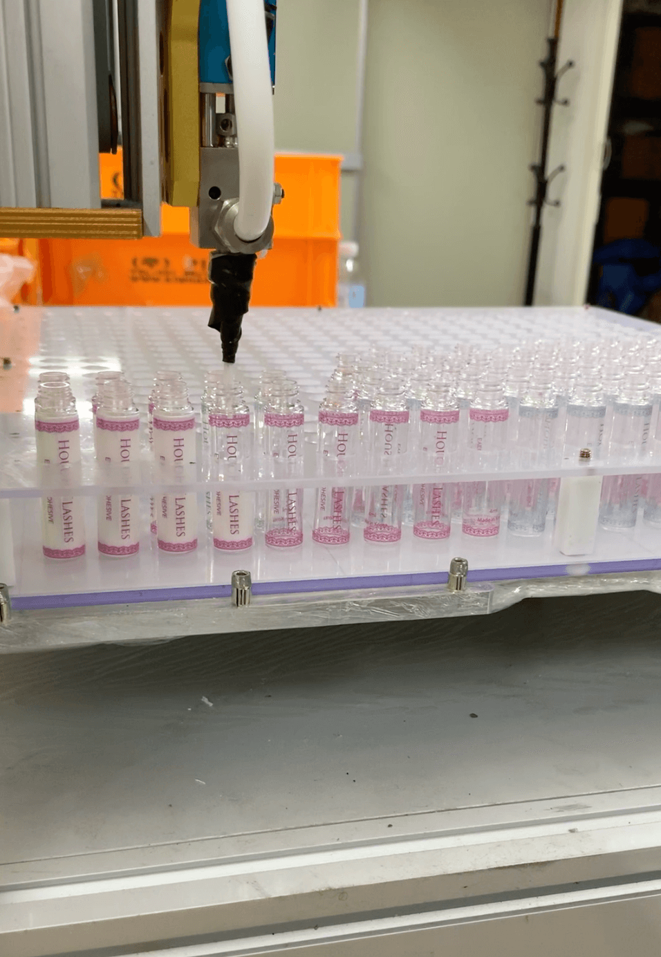 latex-free white lash glue being filled in the factory