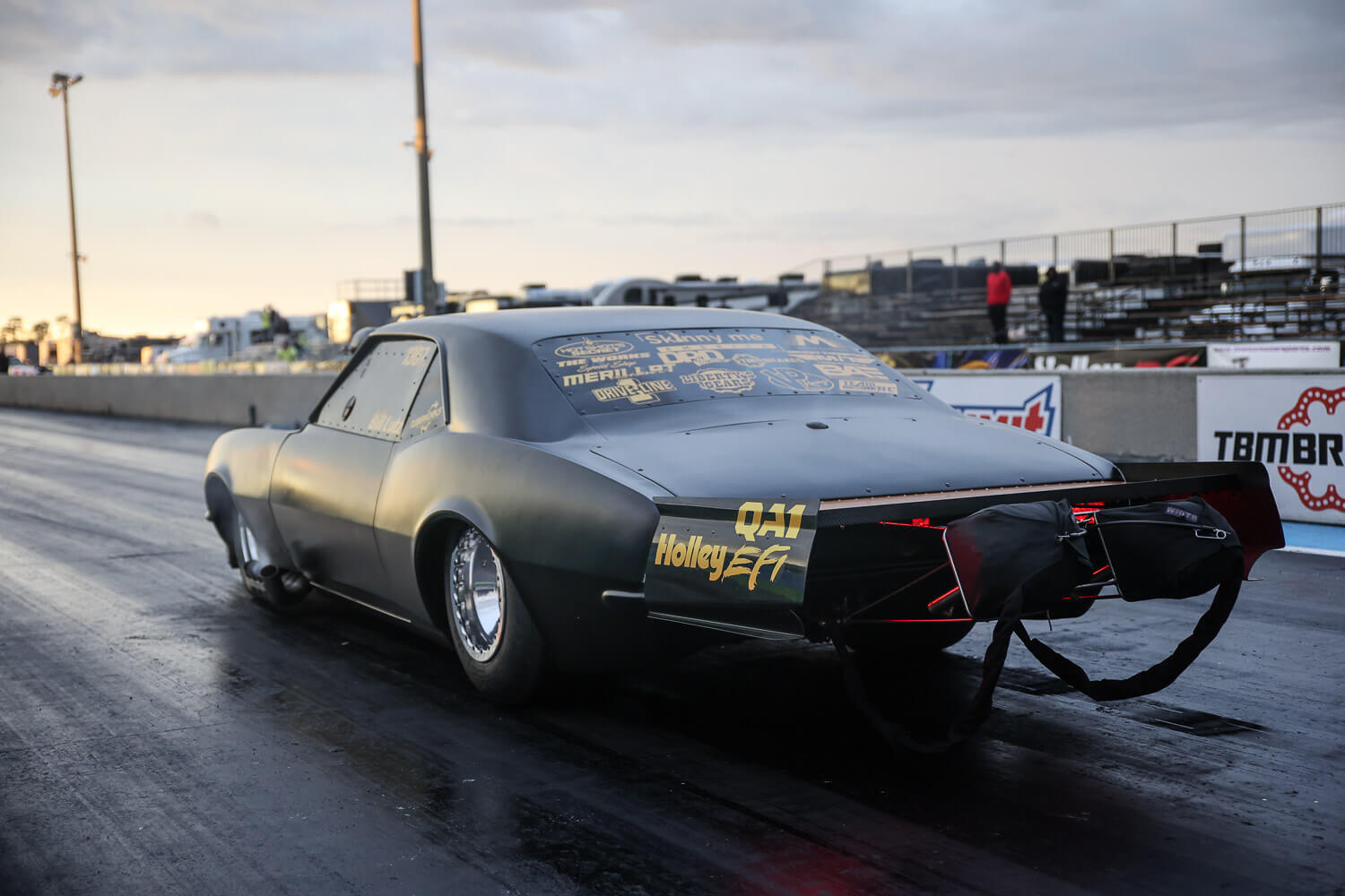 A side-angle shot of Bill Lutz’s 1967 Camaro staging for a No-Time 275 radial race, showcasing its aggressive stance.