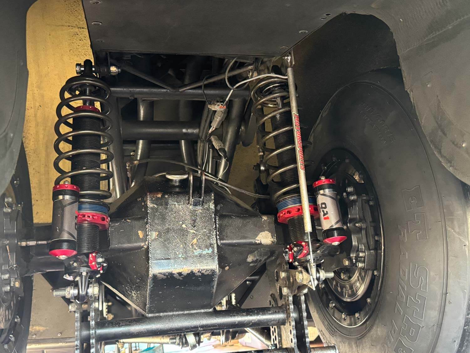 A MOD Series shock mounted in a drag car’s rear suspension, showing how it controls separation and compression forces.