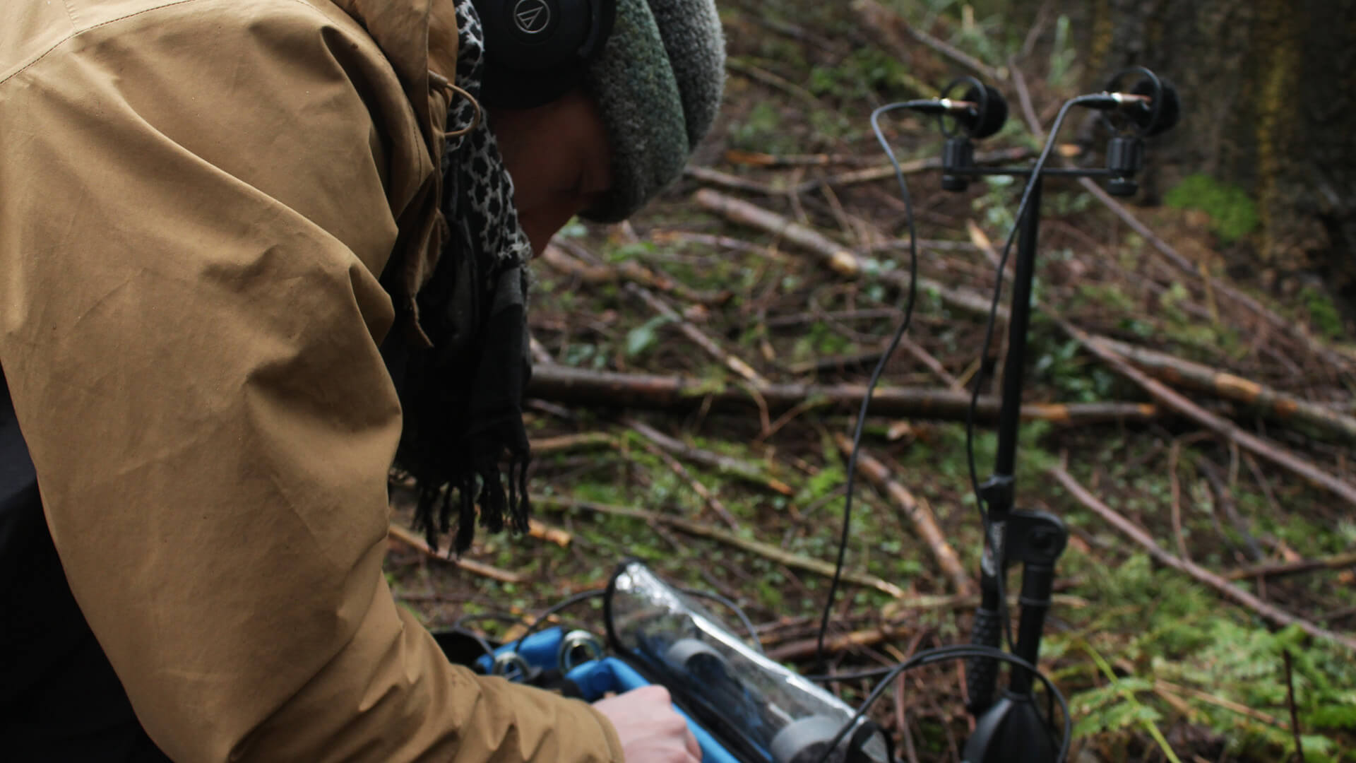 Ezra Gray using microphones in a forest