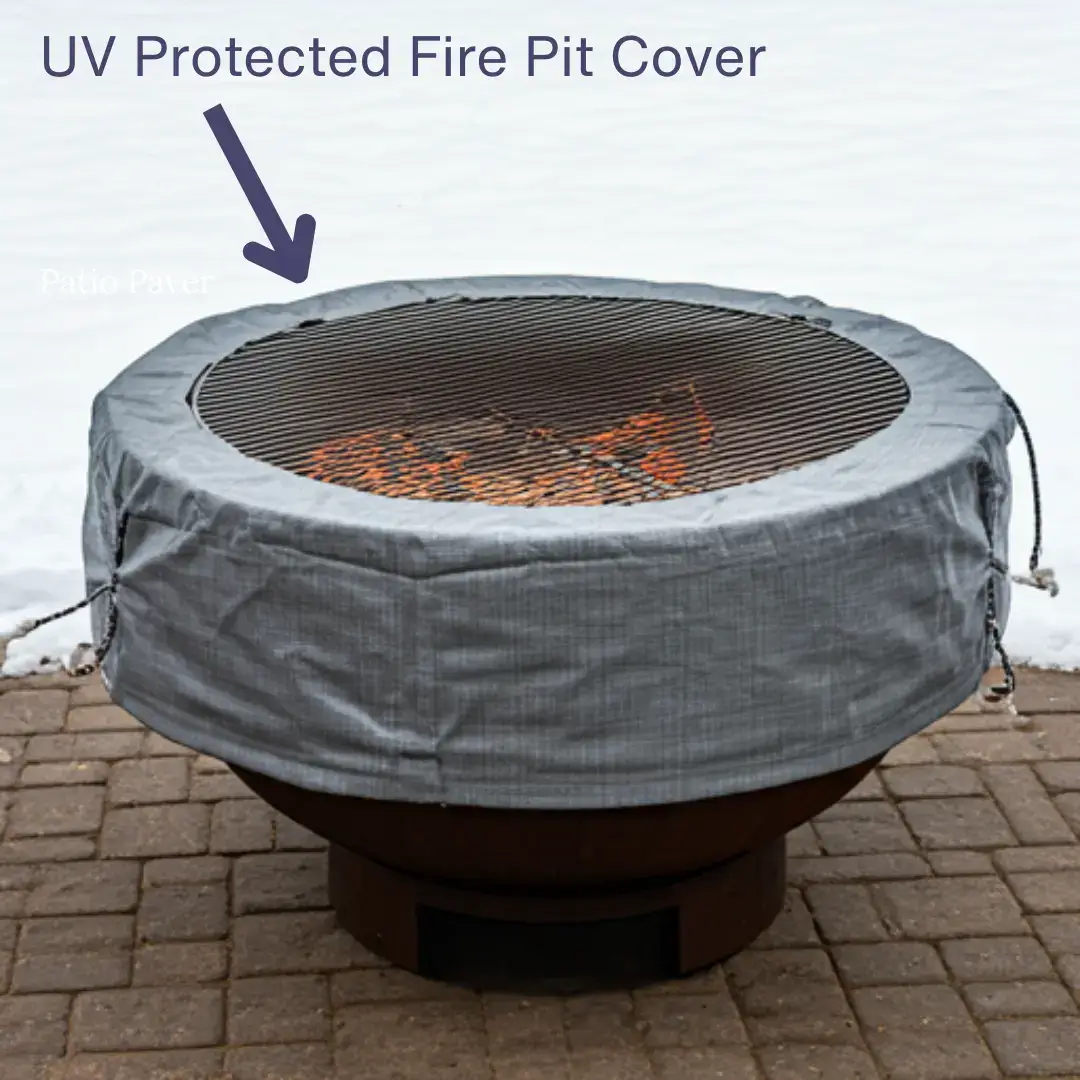 A large, round fire pit covered with a gray, UV-protected cover.