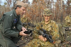 An Australian soldier briefs a U.S. Navy Admiral on the OLD F88 GLA Austeyr
