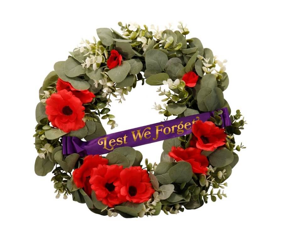 A wreath of flowers and a purple ribbon  Description automatically generated