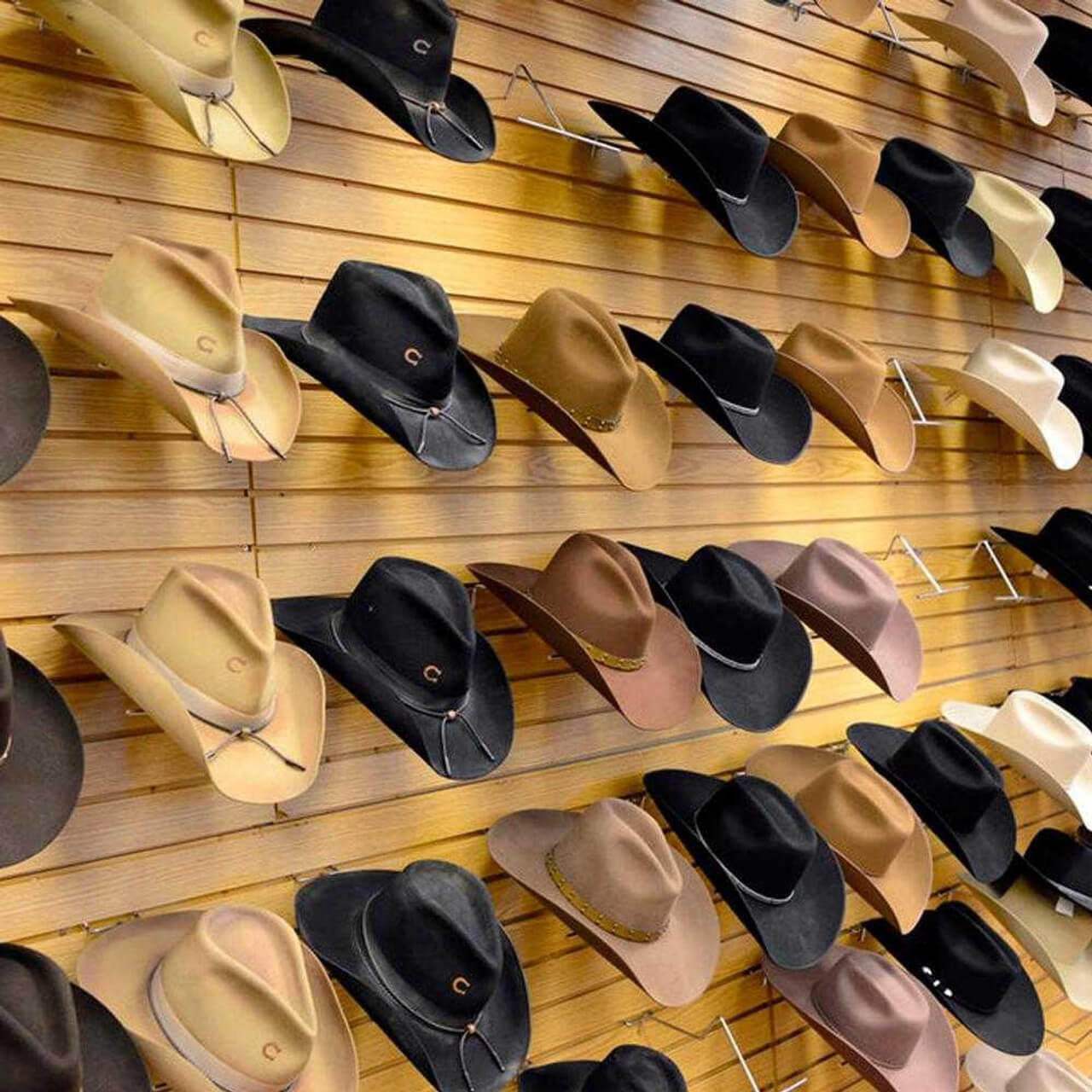 Western hats displayed using slatwall hat holders