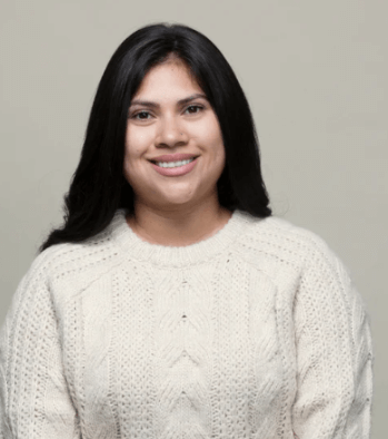 Woman with thinning hair wearing a synthetic hair topper for greater coverage