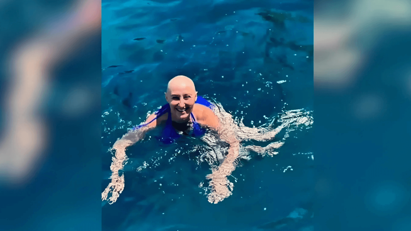 Sondra swimming in Greece without her wig.