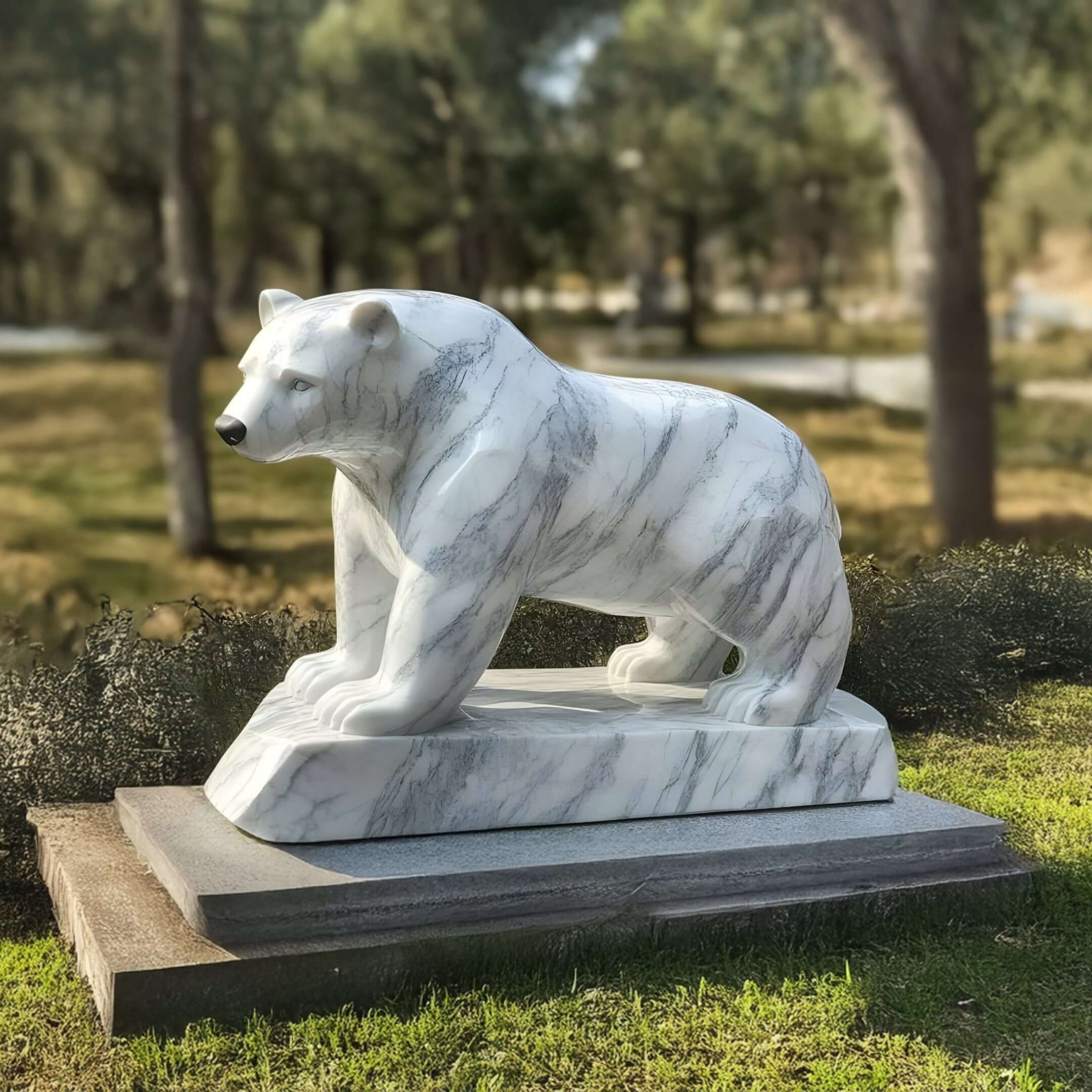 Marble Bear Statue in Nature – A lifelike white marble bear sculpture with grey veining, set in a serene, tree-filled outdoor space.