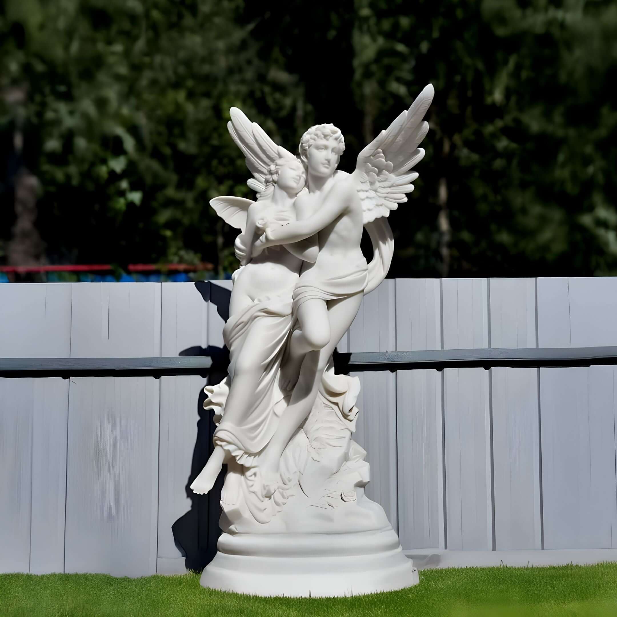 Romantic angel couple statue in a grassy backyard