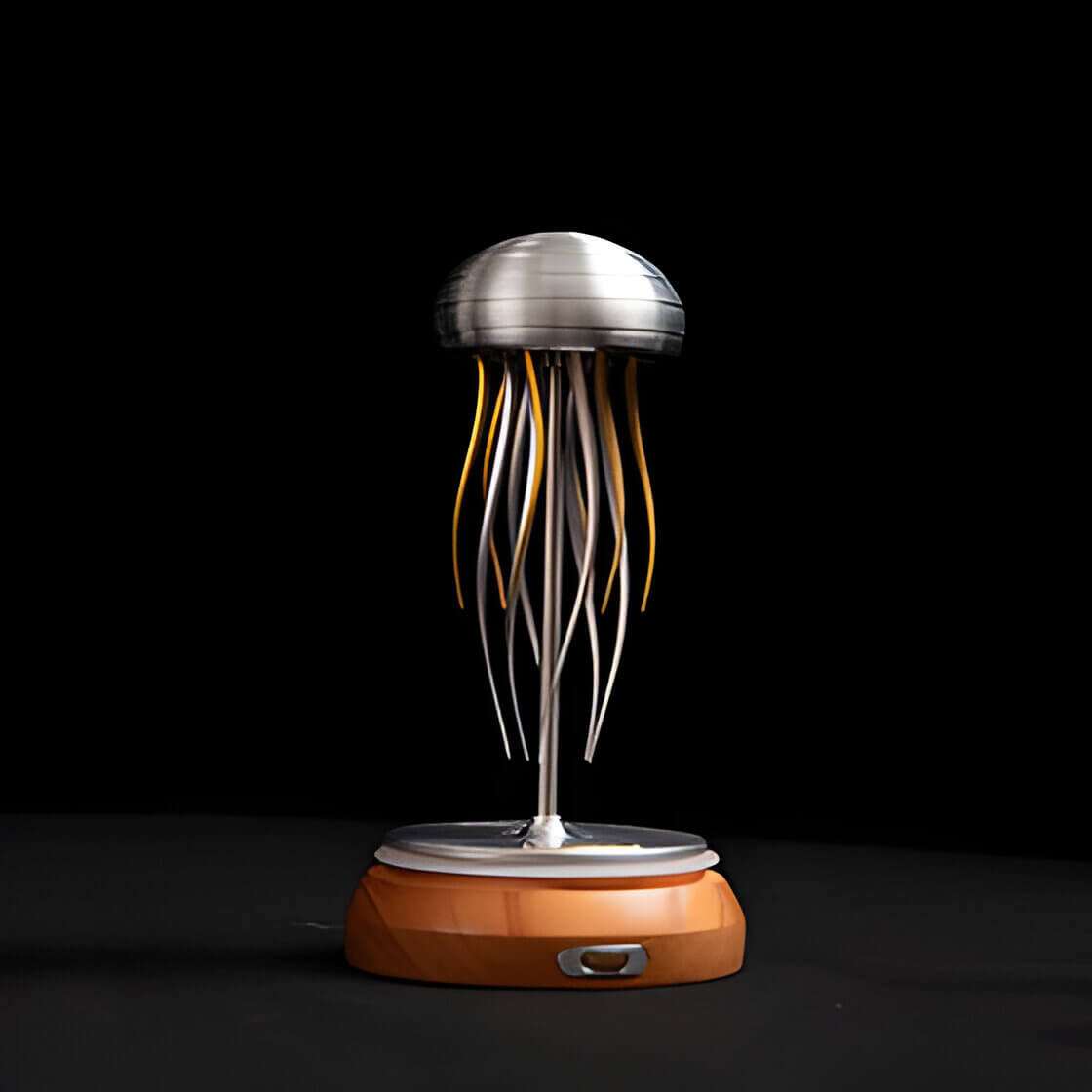 a silver and gold kinetic sculpture of a jelly fish